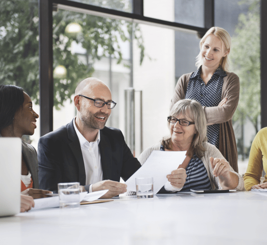 Willis team members review documents at a conference table. Willis provides full aviation advisory and consultancy services