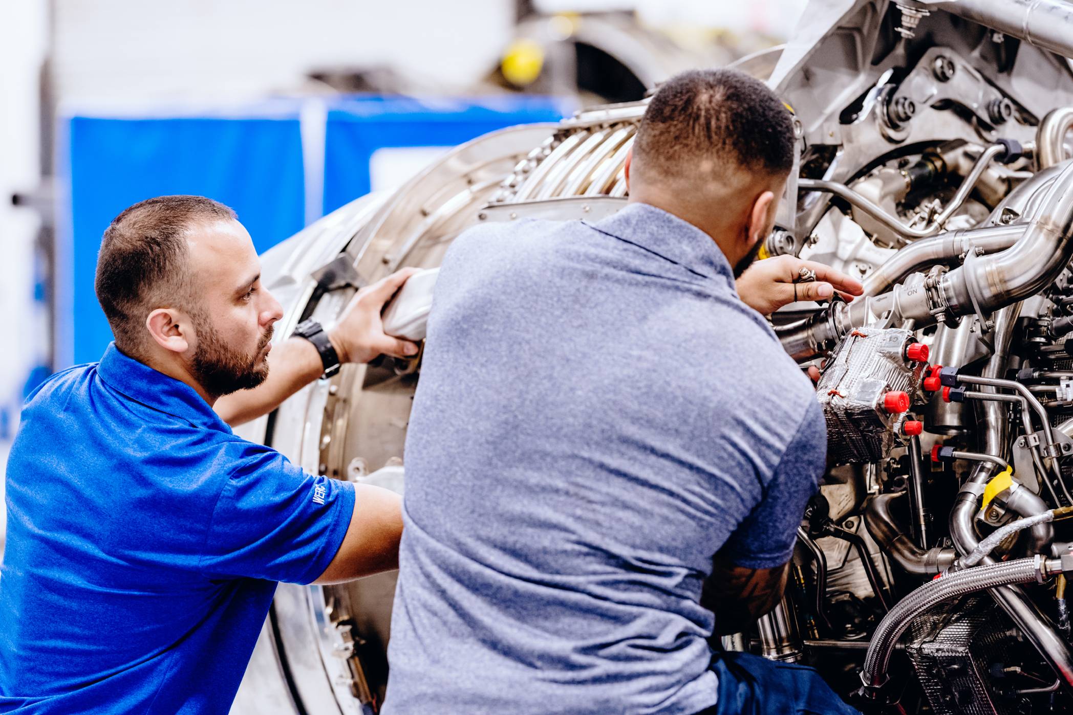 Two Willis aircraft mechanics work on an engine, providing key jet maintenance that is only part of its overall services.